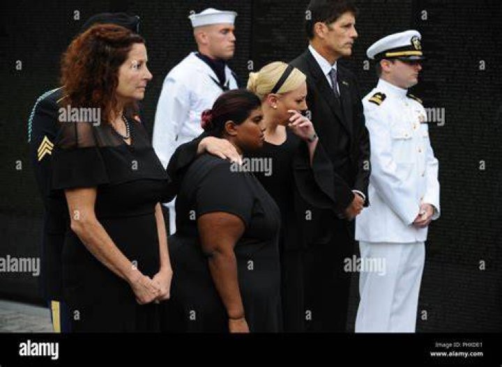 Bridget McCain and Meghan McCain, daughters of Senator John McCain, R-Ariz., watch as Cindy McCain, lays a wreath at the Vietnam Veterans Memorial in Washington,, during a Funeral procession to carry the casket of her husband from the U.S. Capitol to National Cathedral for a Memorial Service. McCain served as a Navy pilot during the Vietnam War and was a prisoner of war for more than five years. Funeral of John McCain, Washington DC, USA - 02 Sep 2018