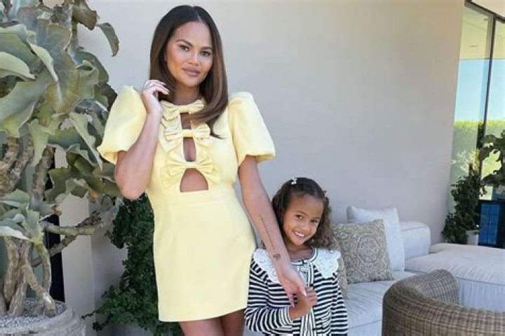 Chrissy Teigen Carries Luna In Her Arms