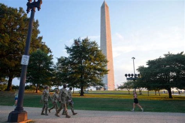 DC National Guard walk around the Capitol grounds, Thursday morning, Jan. 7, 2021 in Washington. The House and Senate certified the Democrat's electoral college win early Thursday after a violent throng of pro-Trump rioters spent hours Wednesday running rampant through the Capitol. A woman was fatally shot, windows were bashed and the mob forced shaken lawmakers and aides to flee the building, shielded by Capitol Police. (AP Photo/Julio Cortez)